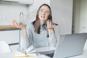 Smiling young woman is sending audio voice message