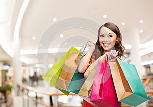 Smiling young woman with shopping bags