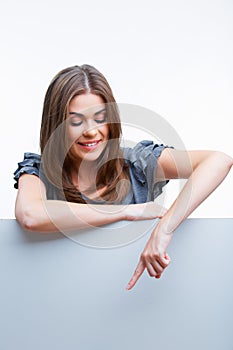 Smiling young woman showing blank signboard