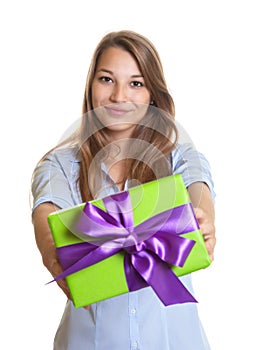 Smiling young woman showing a christmas gift