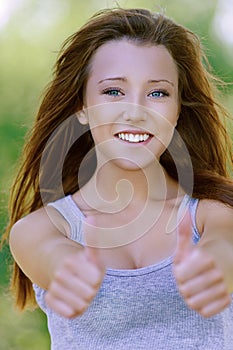 Smiling young woman showing gesture