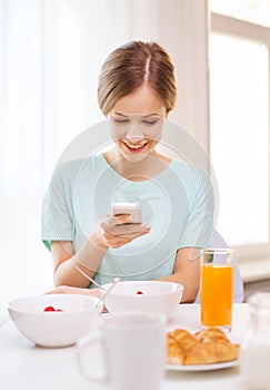 Smiling young woman with smartphone reading news