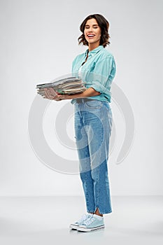 Smiling young woman sorting paper waste
