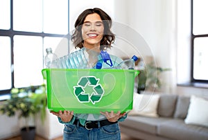 Smiling young woman sorting plastic waste