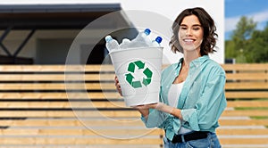 Smiling young woman sorting plastic waste