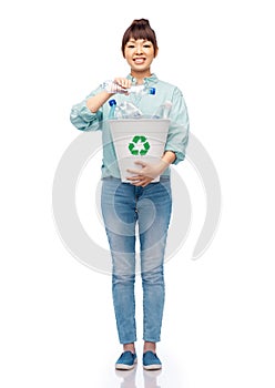 smiling young woman sorting plastic waste