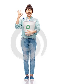 smiling young woman sorting plastic waste