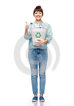 smiling young woman sorting plastic waste