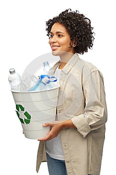 smiling young woman sorting plastic waste