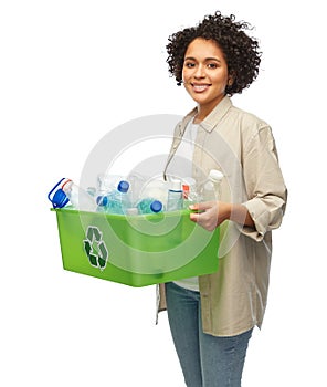 smiling young woman sorting plastic waste