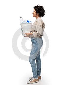 smiling young woman sorting plastic waste