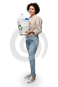 smiling young woman sorting plastic waste