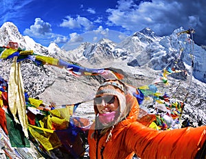 Smiling young woman takes a selfie on mountain peak Kala Patth
