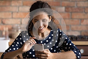 Smiling young woman talk on video call on smartphone