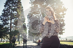 Smiling young woman talking on her smartphone on the street.Communicating with friends,free calls and messages for young people.