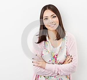 Smiling Young woman teenager arms crossed, in pink