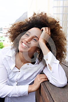 Smiling young woman thinking and looking up