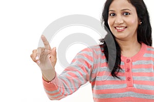 Smiling young woman touching imaginary screen