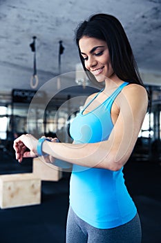 Smiling young woman using activity tracker