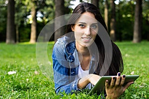 Smiling young woman using digital tablet