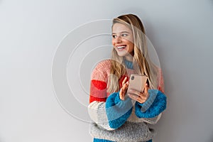 Smiling young woman using smartphone