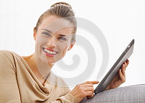 Smiling young woman using tablet pc