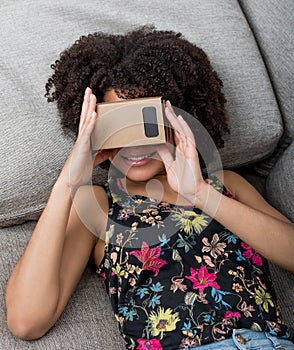 Smiling young woman using virtual reality device