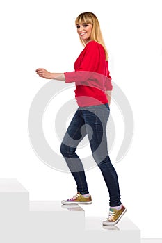 Smiling Young Woman Is Walking Up The Stairs