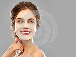 Smiling young woman wearing sheet facial mask