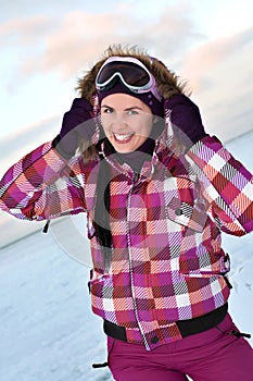 Smiling young woman wearing skiing suit photo