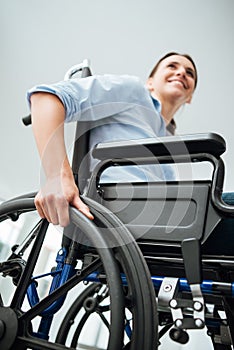 Smiling young woman in wheelchair