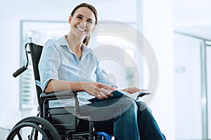 Smiling young woman in wheelchair