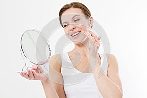 Smiling young woman with white teeth looking in mirror isolated on white background. Skin care and anti aging concept. Beauty