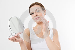 Smiling young woman with white teeth looking in mirror isolated on white background. Skin care and anti aging concept. Beauty