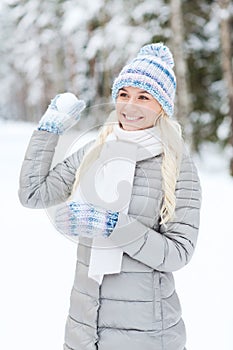 Smiling young woman in winter forest