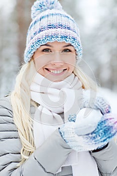 Smiling young woman in winter forest