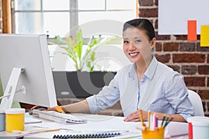 Smiling young woman working at desk