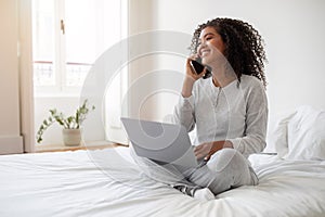 Smiling Young Woman Working From Home on Her Laptop