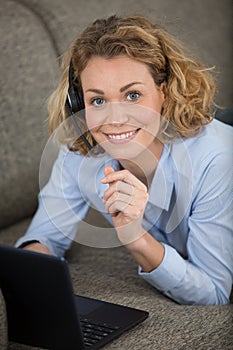 smiling young woman working from sofa