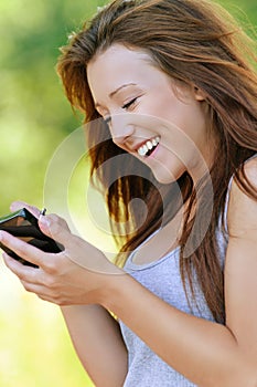 Smiling young woman writing on photo