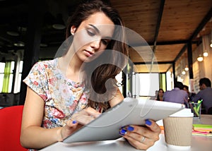 Smiling young women using digital tablet in office