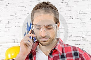 Smiling young worker phone, in his studio