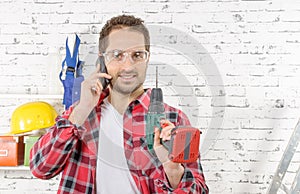 Smiling young worker phone, in his studio