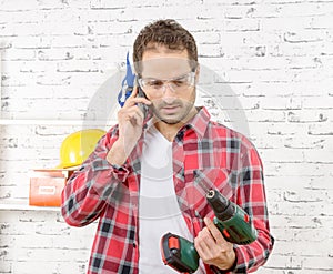 Smiling young worker phone, in his studio