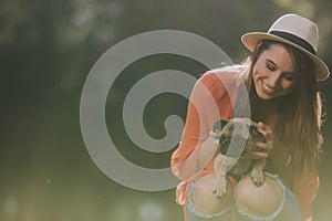 Smilling cute woman is holding her dog