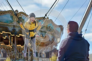 Smilling girl jumping on a trampoline with insurance