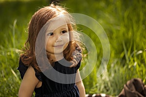 Smilling little girl on a grass