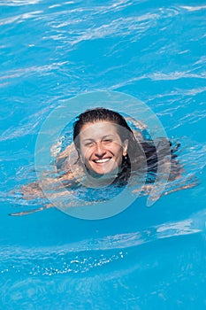Smilling woman in swimming pool