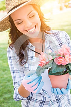 Smilng Adult Woman Wearing Hat and Gloves Gardening Outdoors