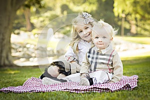 Smilng Little Girl with Her Baby Brother at the Park